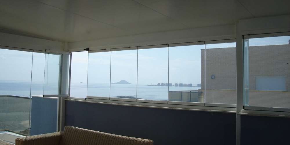Terraza acristalada en la costa mediterránea_ luz y diseño